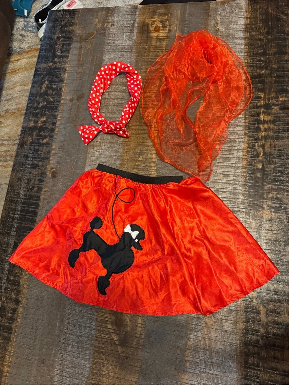 1950s-style red poodle skirt costume with a matching polka dot head band & scarf